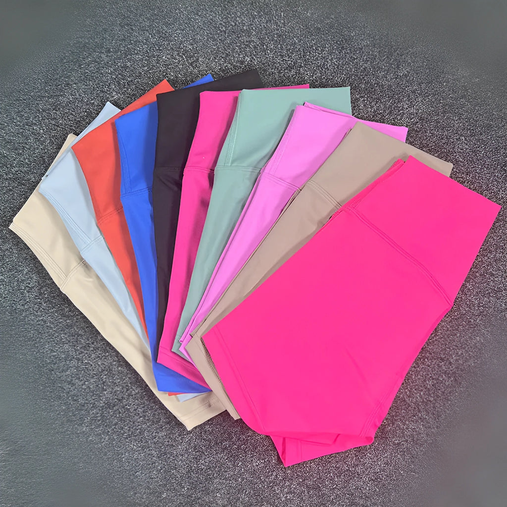 Ladies high-waisted nylon yoga shorts in various colours on a rack