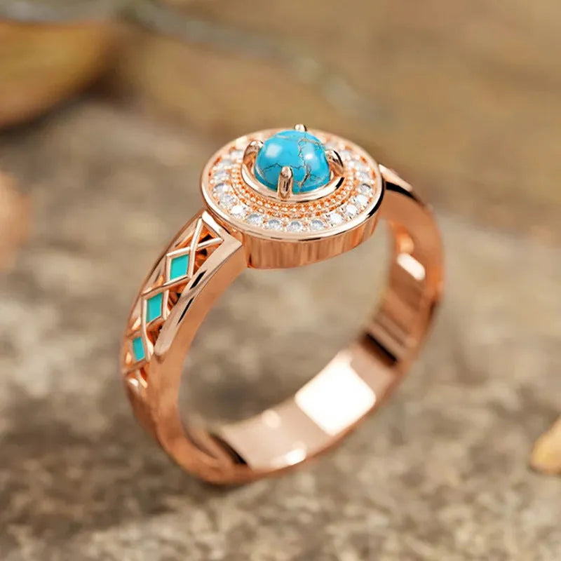 Women's turquoise geometric square ring with inlaid zircon stones on a rose gold band.