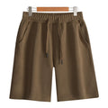 Cotton straight-leg sports shorts in light grey colour showing micro-elastic fabric and fifth pants length
