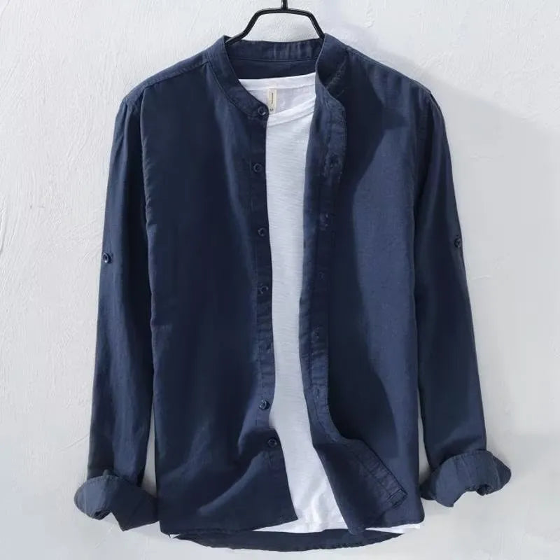 Man wearing a loose fit light blue cotton linen long sleeve casual shirt.