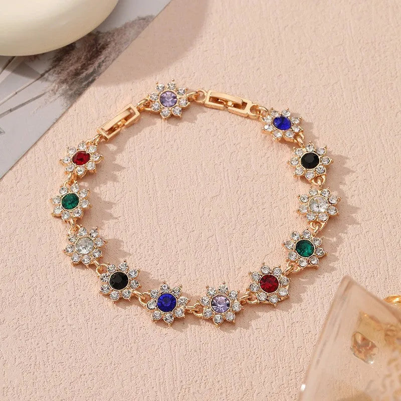 Floral coloured gemstone bracelet in zinc alloy with electroplated gold and silver crystal finishes.