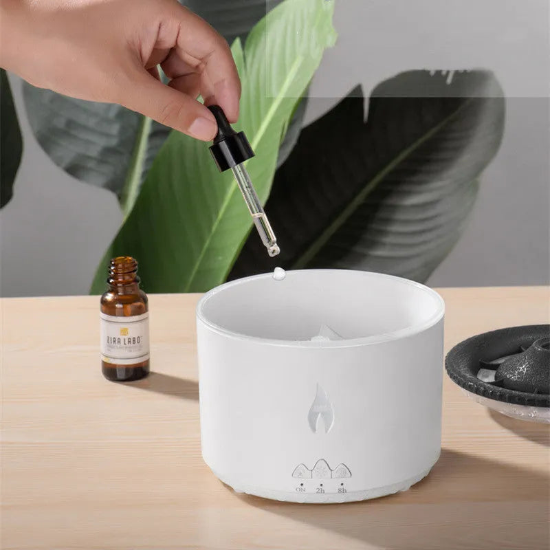 Volcanic-shaped humidifier emitting a two-colour mist from its spray ring on a table.