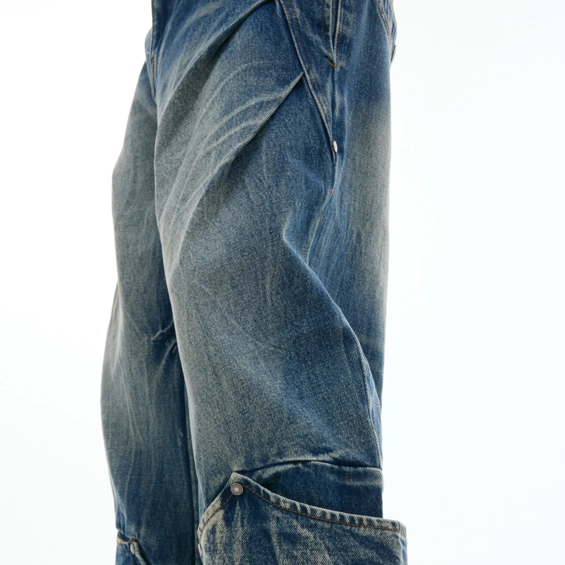 Men's verdant blue loose-fit jeans with a washed burst pattern and curved knife design.