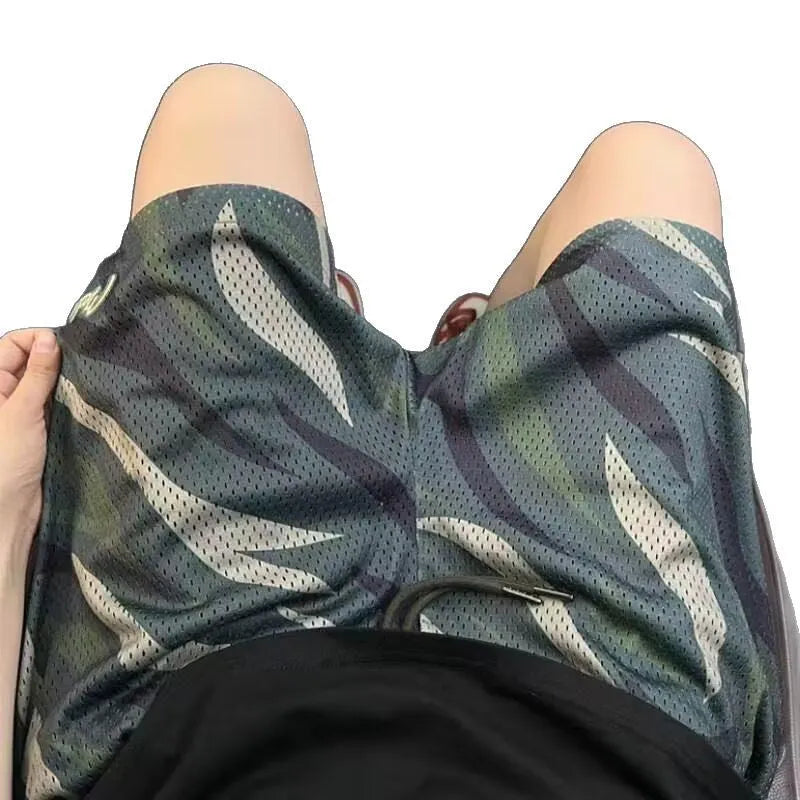 Men's straight leg camouflage shorts in cotton blend fabric on a hanger.