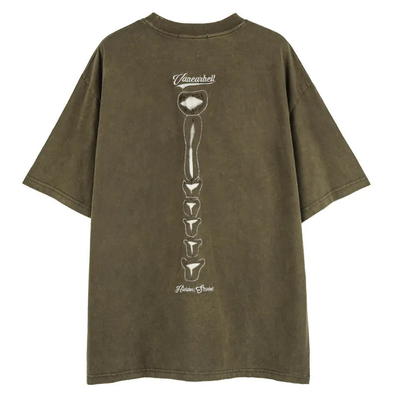 Man wearing a black loose-fit cotton T-shirt with a printed skull and letters graphic and drop-shoulder sleeves.