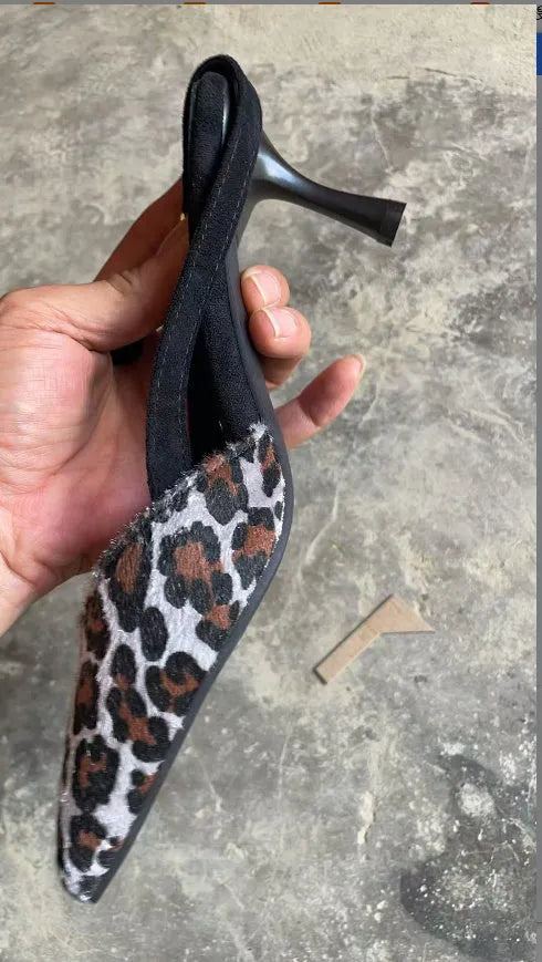 Leopard print suede women's sandals with a pointed toe and a heel.