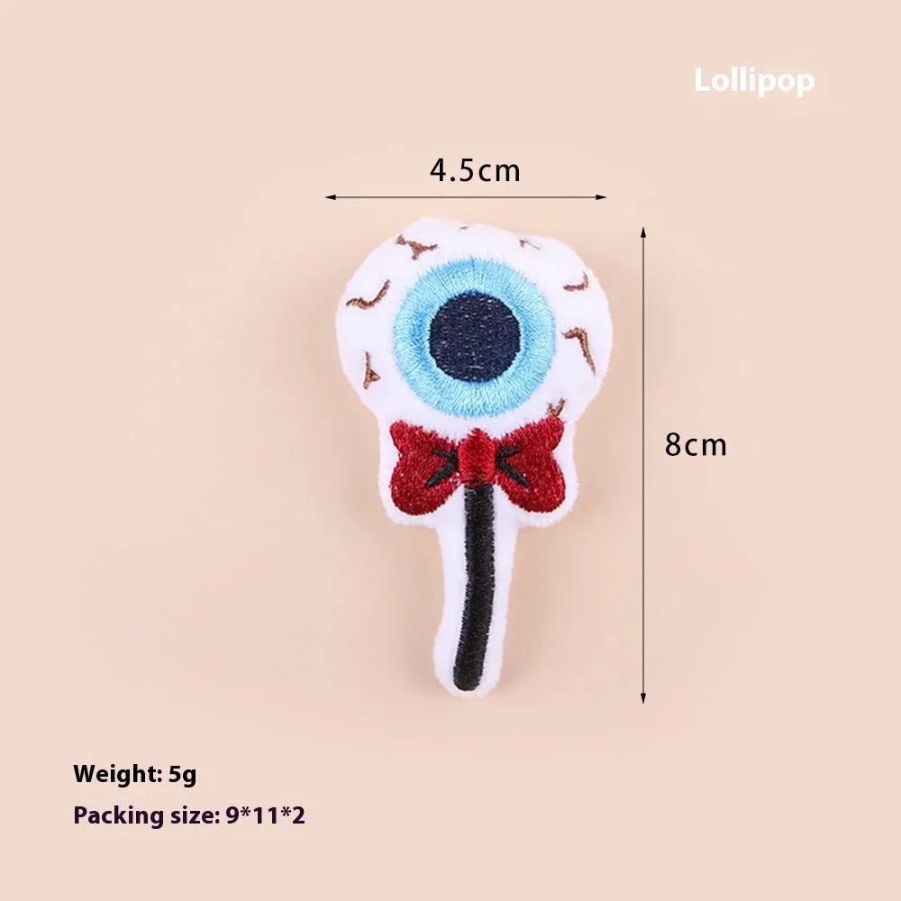 Small cat teaser toy with eyes, candy and skull plush designs on lightweight wand