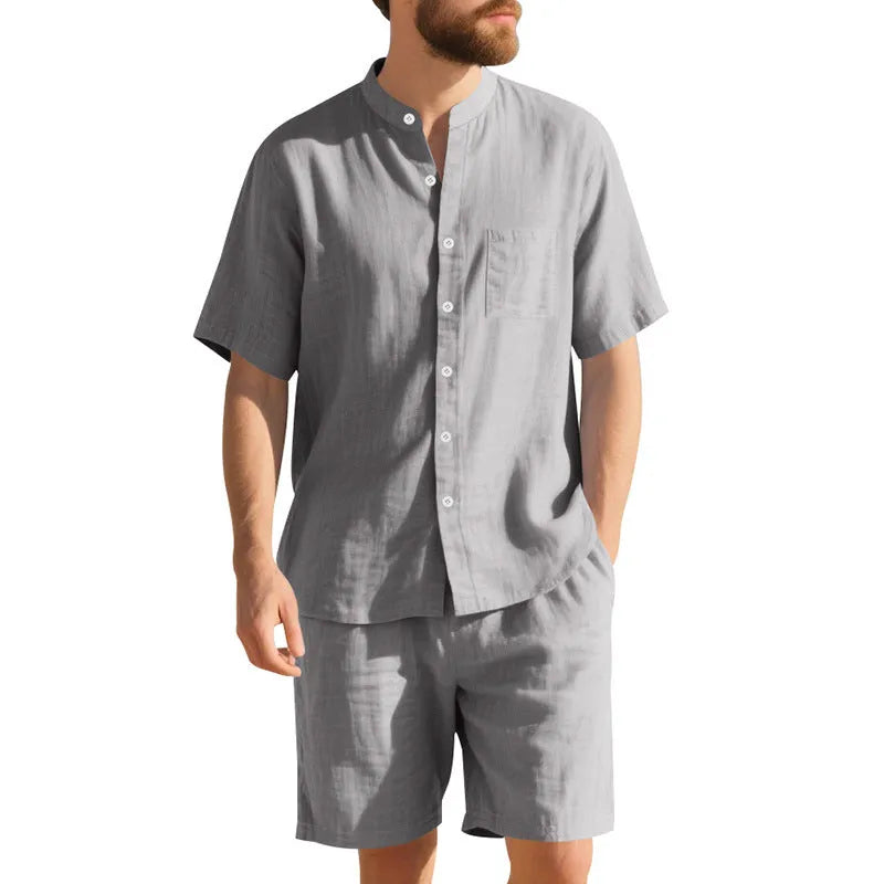 Men's light blue linen two-piece suit with short-sleeved henry collar shirt jacket and shorts on a hanger.