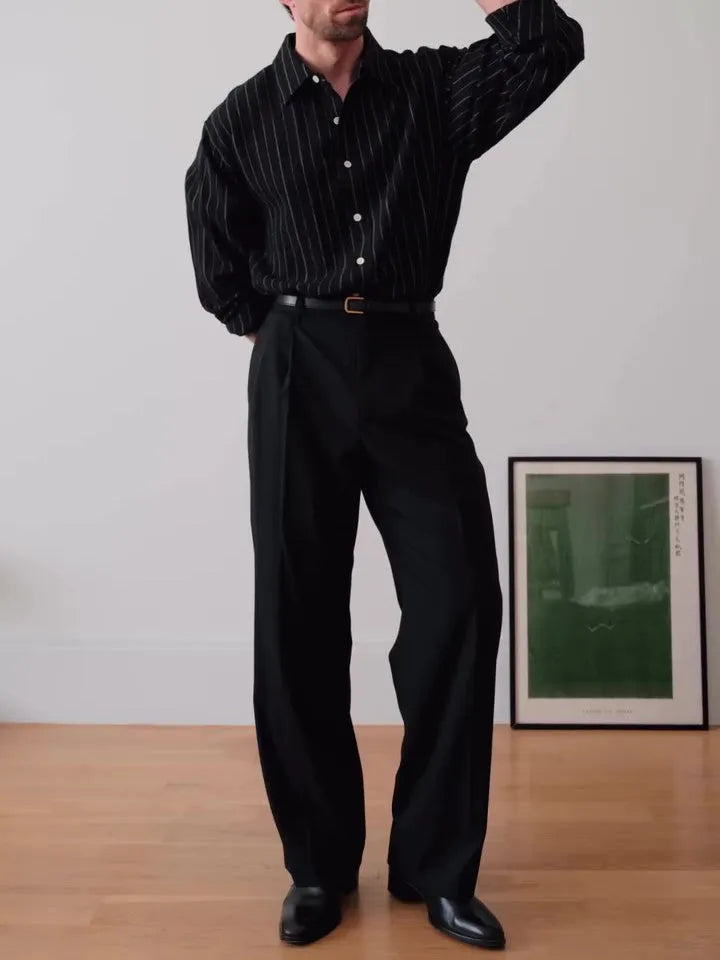 Black pinstriped button-down polyester shirt with a regular fit on a hanger.