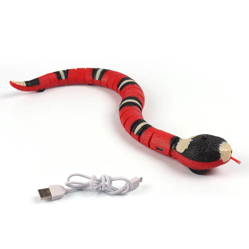 Automatic electronic snake cat toy with segmented plastic body on a floor.