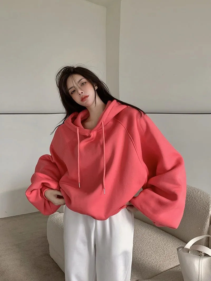 Watermelon red women's loose hooded pullover sweater made from mulberry silk fabric.