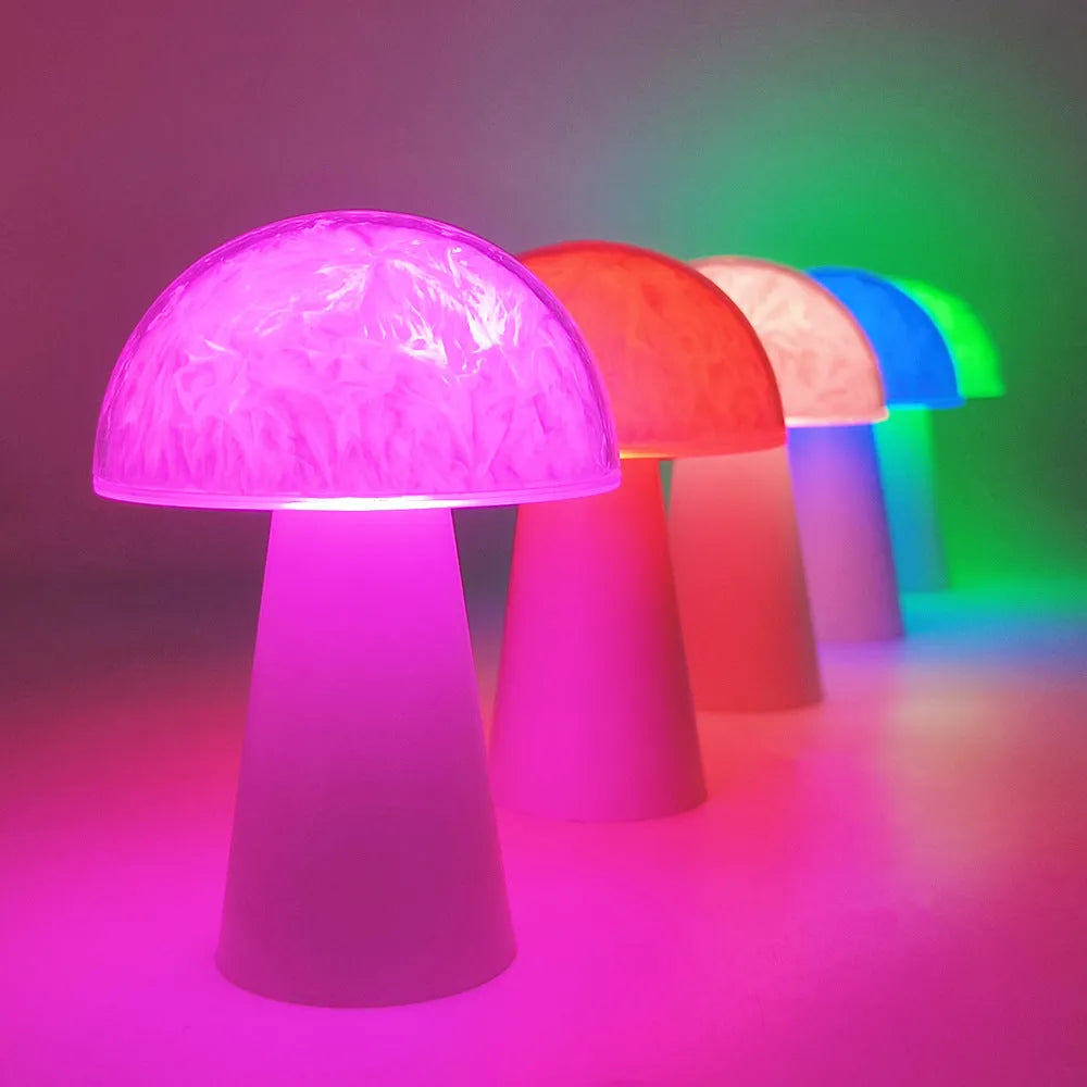 Mushroom-shaped RGB colour-changing night light with remote control on wooden surface