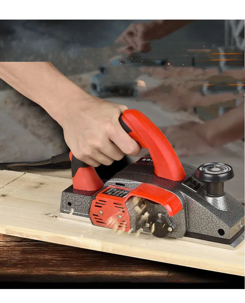 Red desktop electric planer with aluminium housing for woodworking showing 82mm planing width