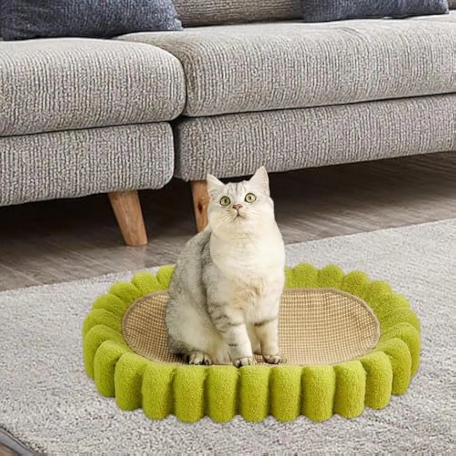 Green oval-shaped sisal cat scratching pad lounge bed on a floor.