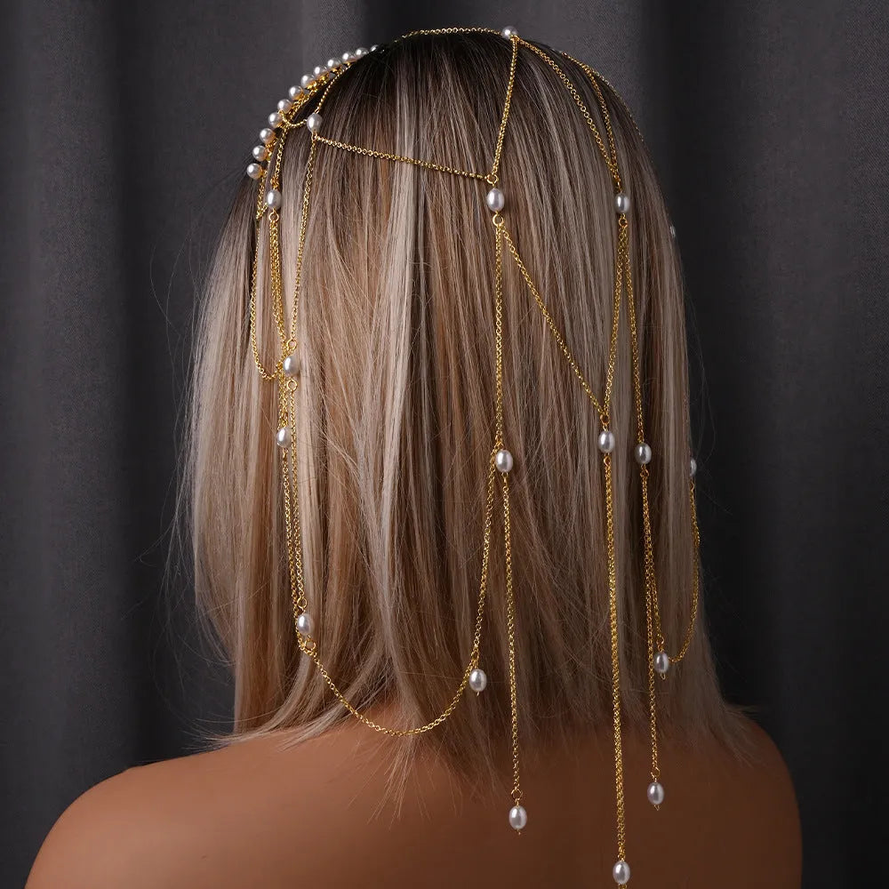 Women's decorative hair chain with pearl bead and tassel in gold or silver electroplated finish.