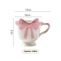 Ceramic mug with heart and bow design in white or black pink colours