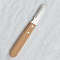 Pet stripping comb with wood handle and metal blade for dog and cat grooming.