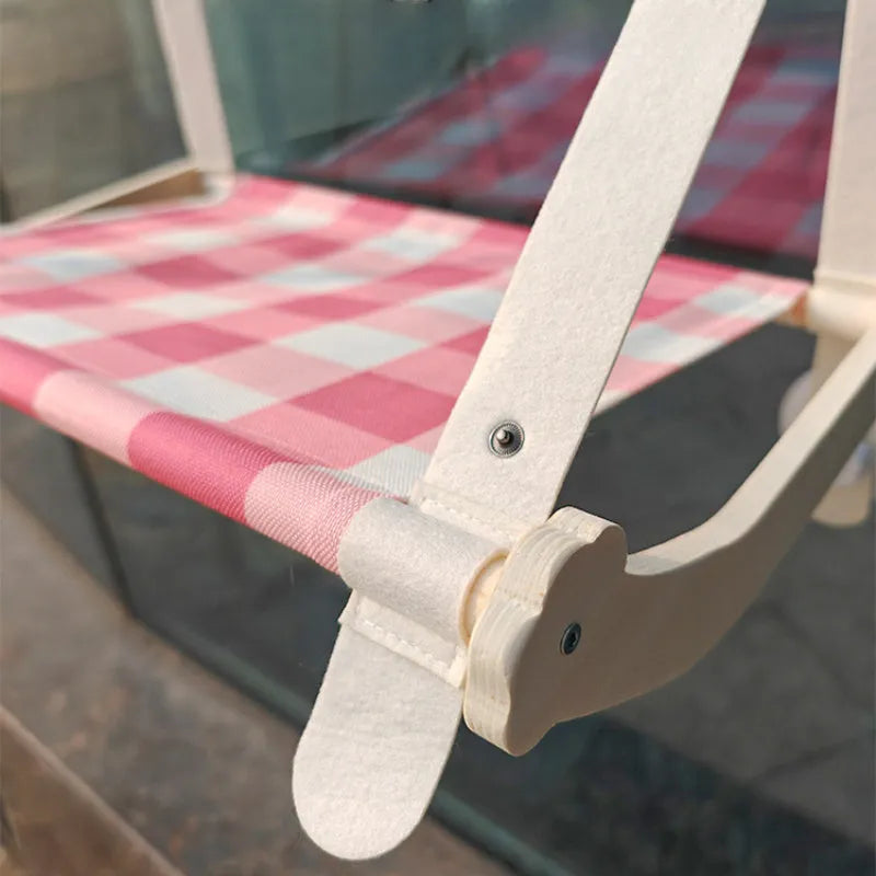 Wooden frame cat window hammock bed with linen fabric attached by suction cups to a window.