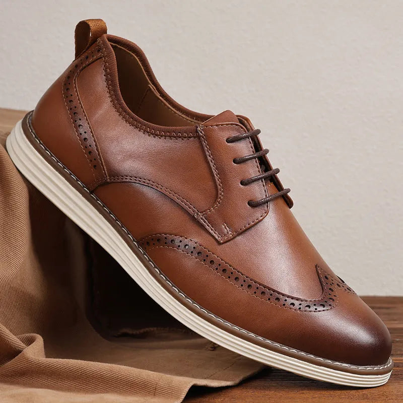 Men's black slip-on business casual shoes with decorative carving on the PU leather upper