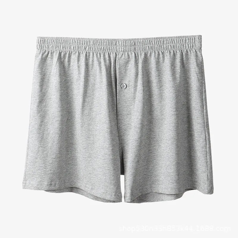 Men's solid colour cotton boxer shorts with a high waist and loose fit on a neutral background.