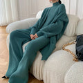 Women's knitted three-piece clothing set showing wide-leg pants, sweater and cardigan in solid colour with leather stitching details