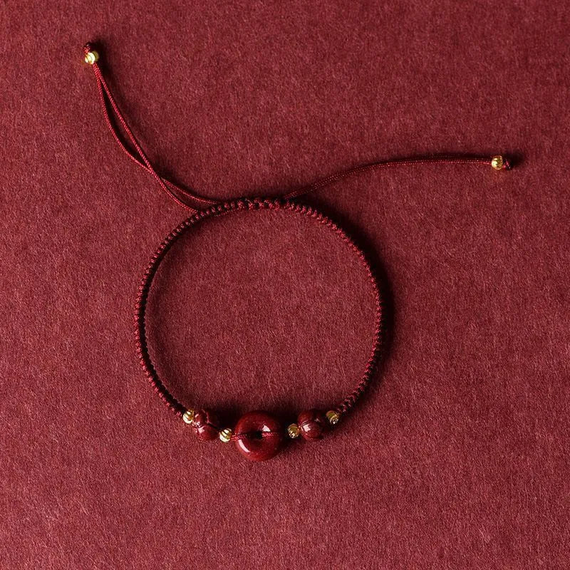 Cinnabar safety buckle bracelet with heart-shaped charm on rope cord