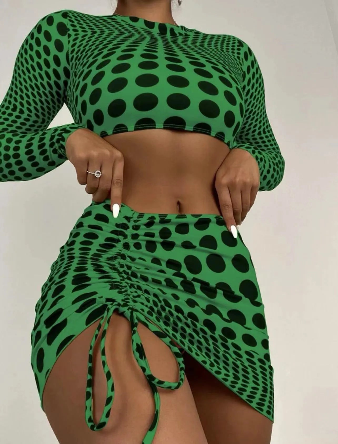 Women's green polka dot swimsuit three-piece set showing top, skirt and bra components