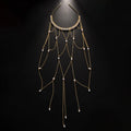 Women's decorative hair chain with pearl bead and tassel in gold or silver electroplated finish.