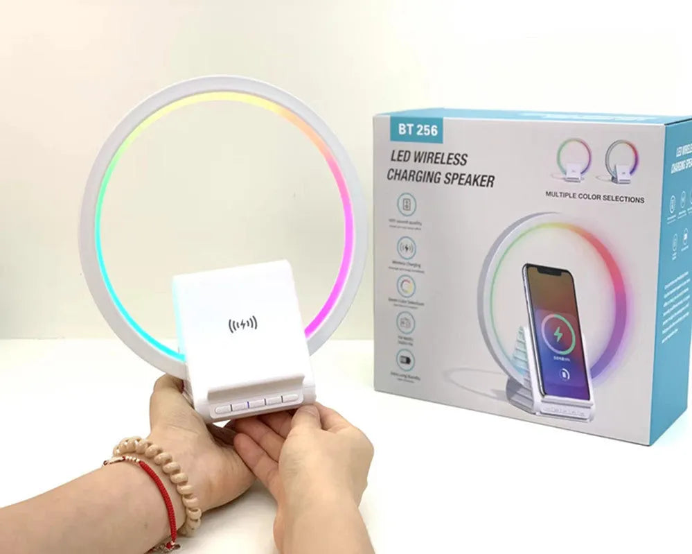 White smart Bluetooth speaker with integrated ambient lighting and a 15W wireless charging pad on top.