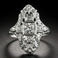 Geometric hollow out silver ring with diamond studs on a copper base.