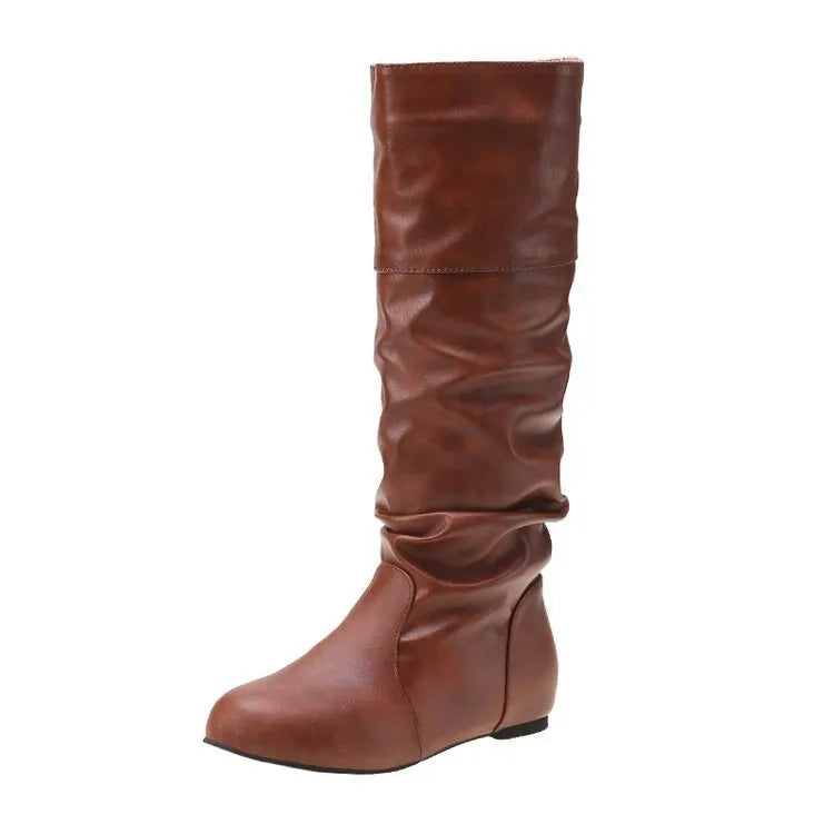 Women's black flat slip-on ankle boots with round toe and high shaft on a neutral background