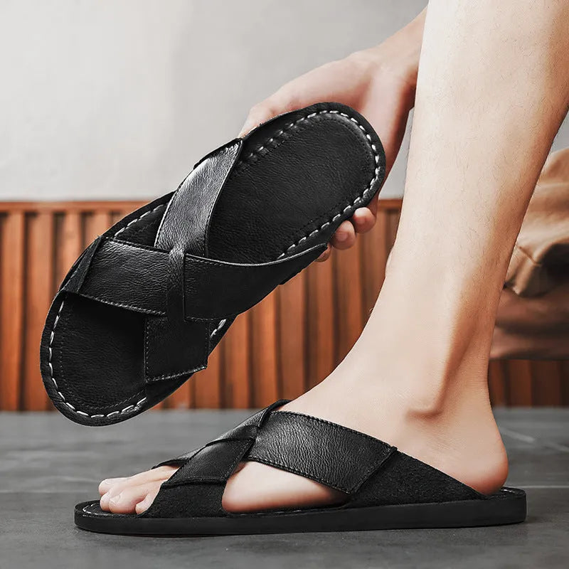 Men's black genuine leather slip-on sandals with a rubber sole on a plain background.
