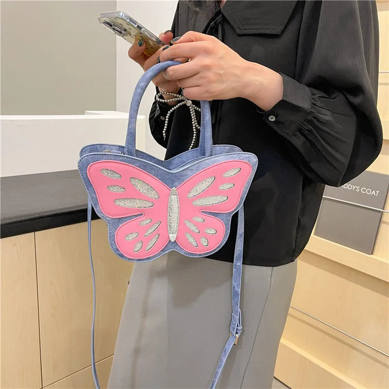 Small square white PU crossbody bag with blue contrast trim on a table.