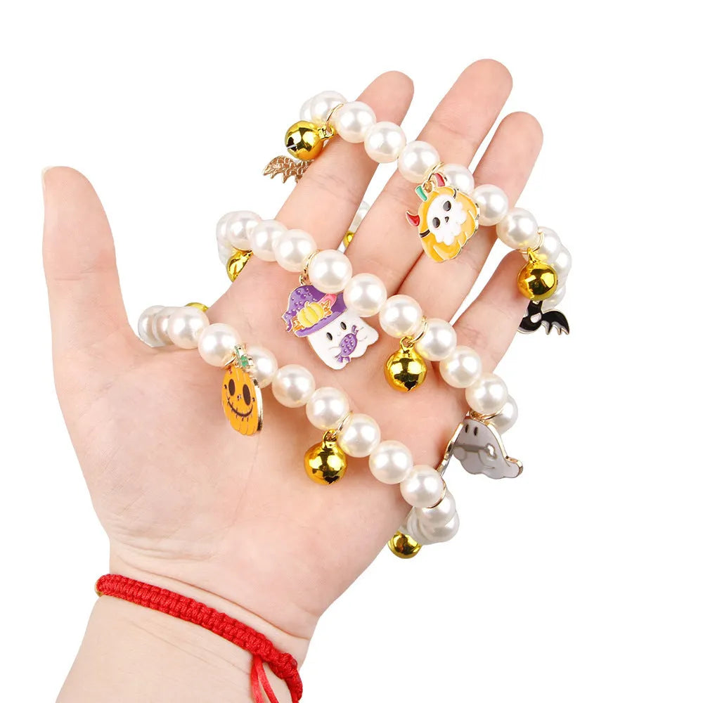 Halloween pet collar charm with simulated pearls and a choice of pumpkin or ghost decoration.