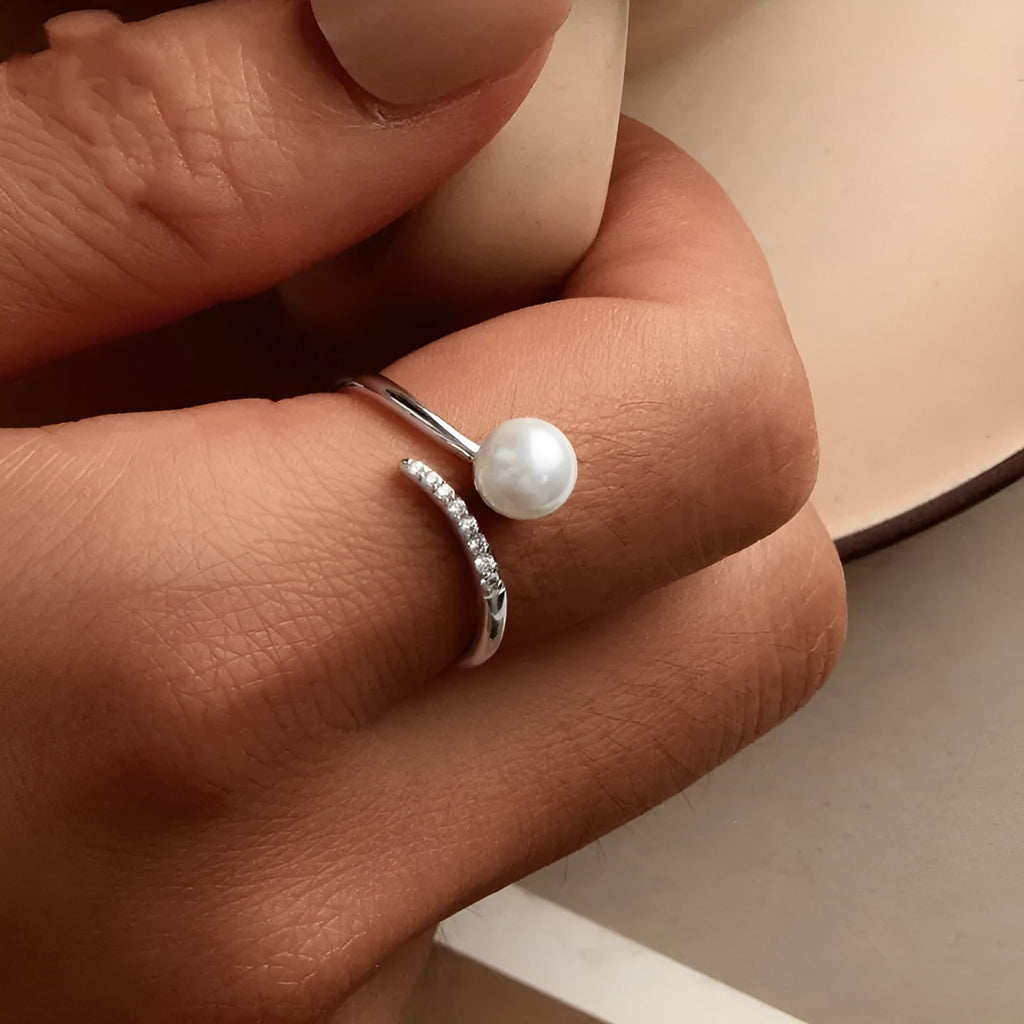 Women's adjustable sterling silver ring with shell pearls and open loop design