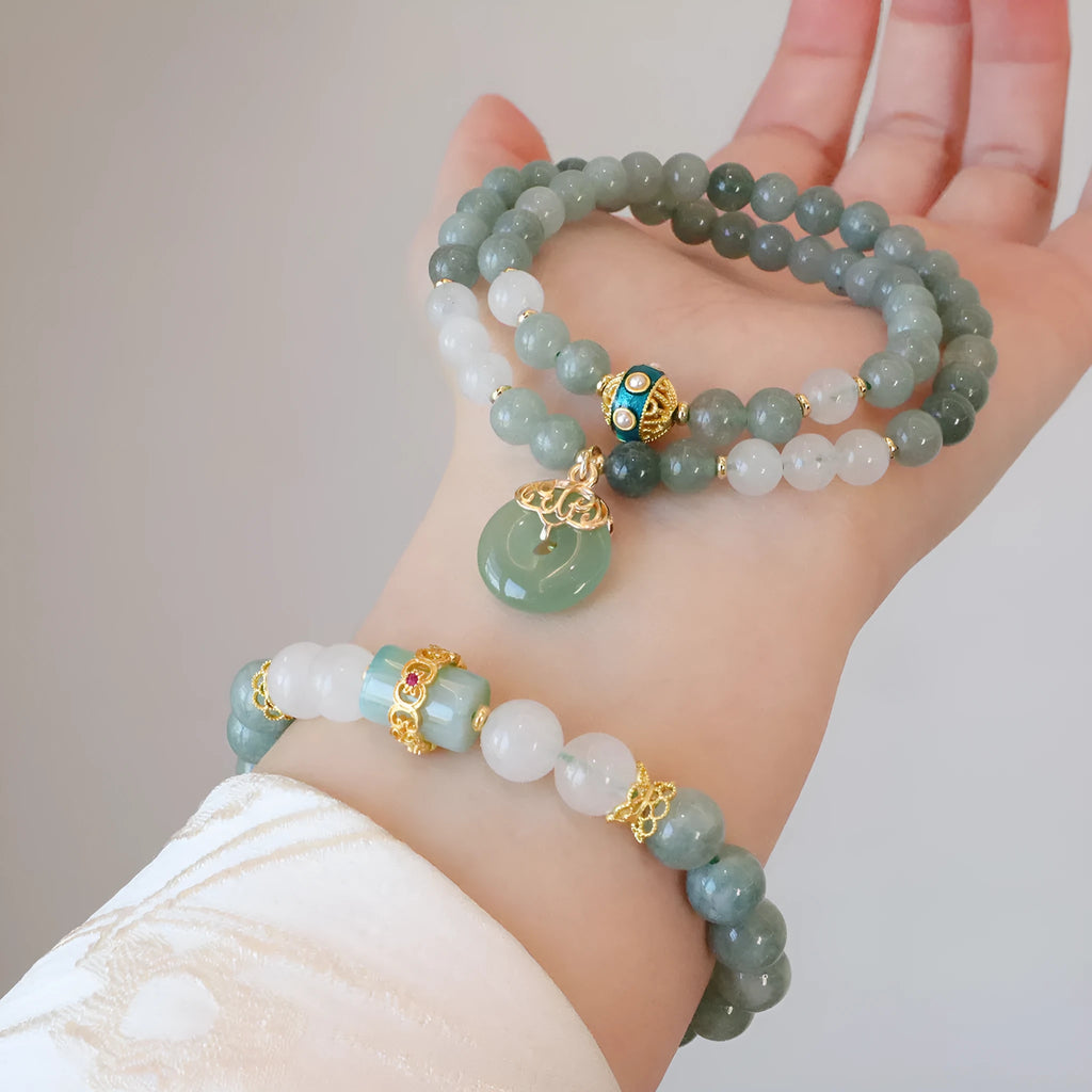 Women's bracelet with a Myanmar jade safety buckle pendant and lucky beads on a geometric crystal band.