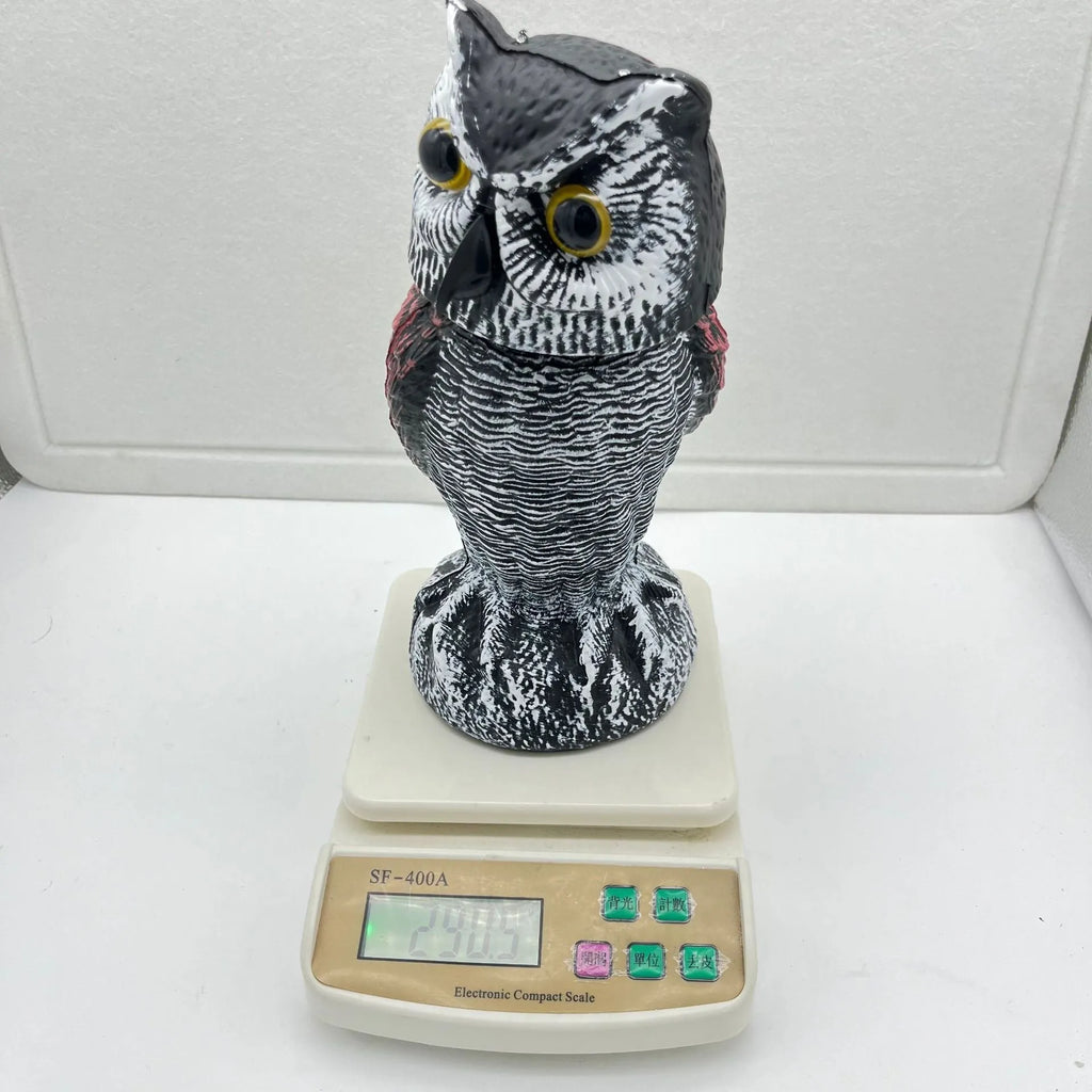 Realistic plastic artificial owl bird deterrent ornament with shaking head, for outdoor use.