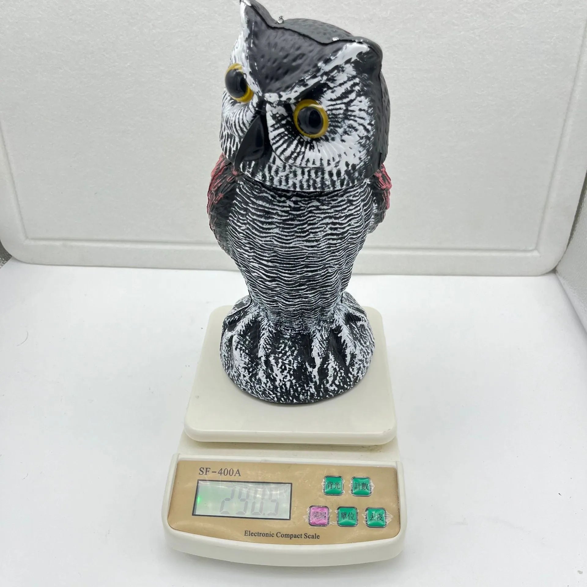 Realistic plastic artificial owl bird deterrent ornament with shaking head, for outdoor use.