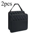 Black leather hanging storage bag for car interior, shown mounted on a headrest.