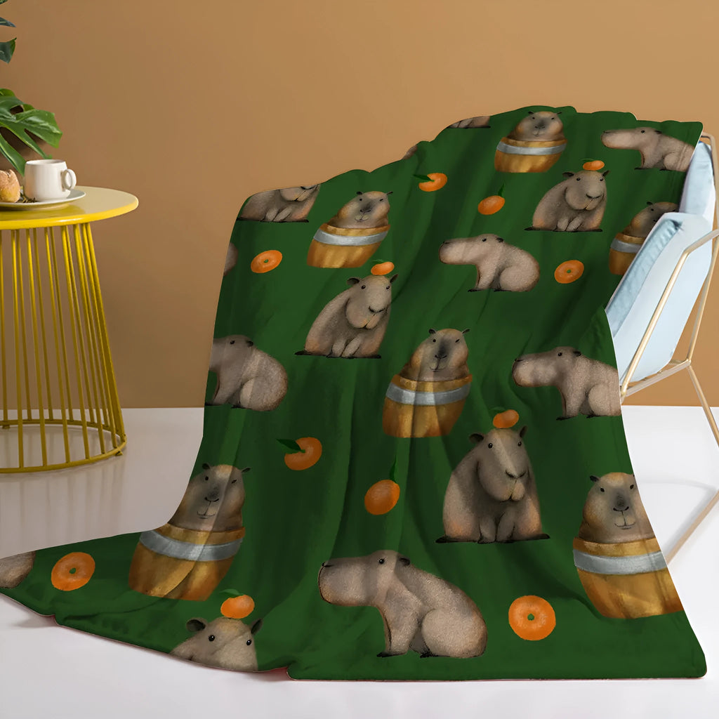 Flannel fleece blanket with orange capybara print, soft fluffy throw in three sizes with hemmed edges.
