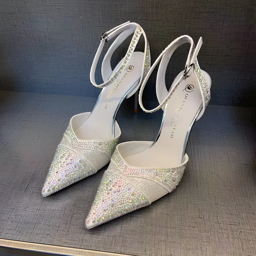 Women's black stiletto heels with pointed toe, hollowed design and red sole