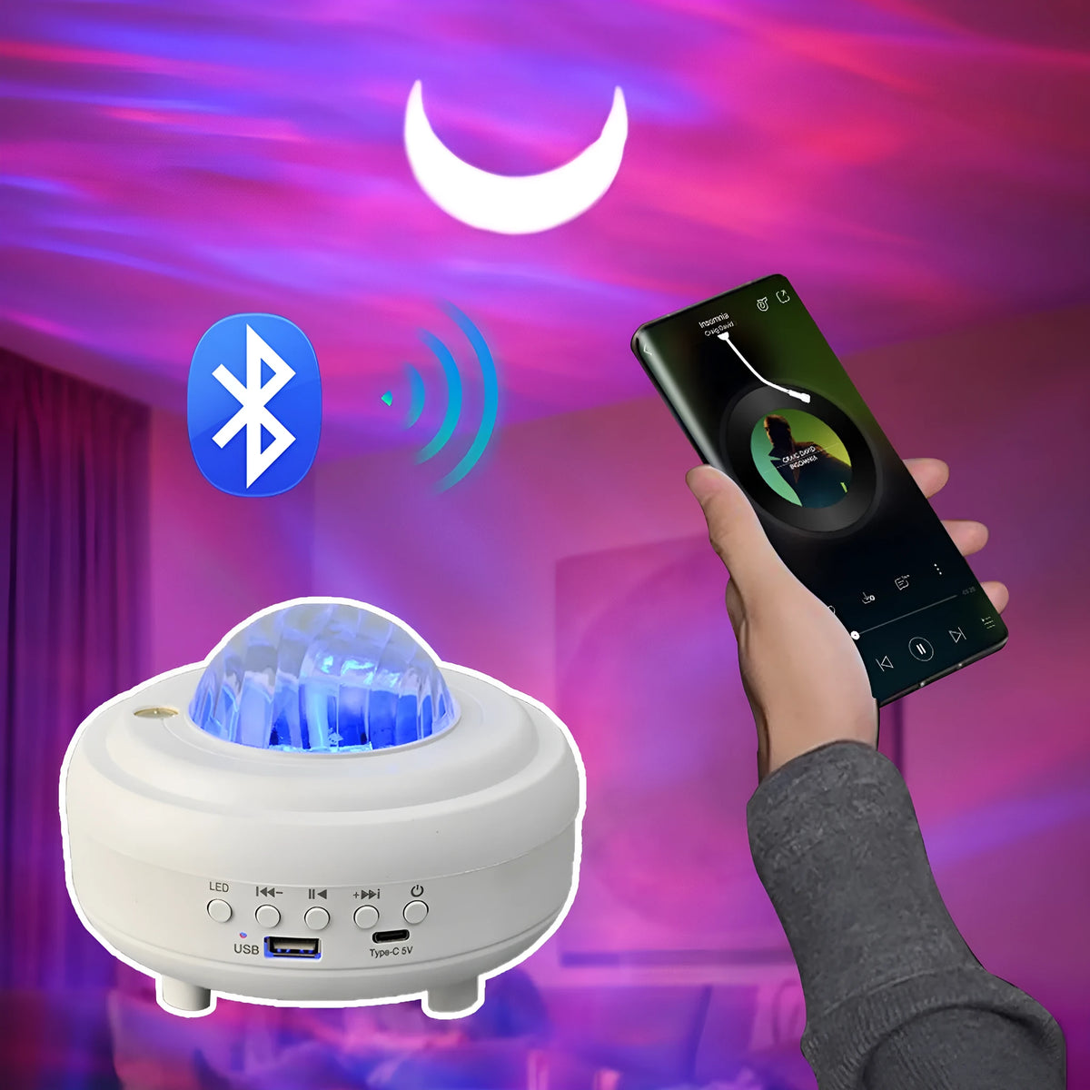 White Galaxy Star Projector night light with Bluetooth speaker on a table