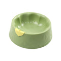 Green plastic pet bowl with dual compartments for food and water, anti-tipping design