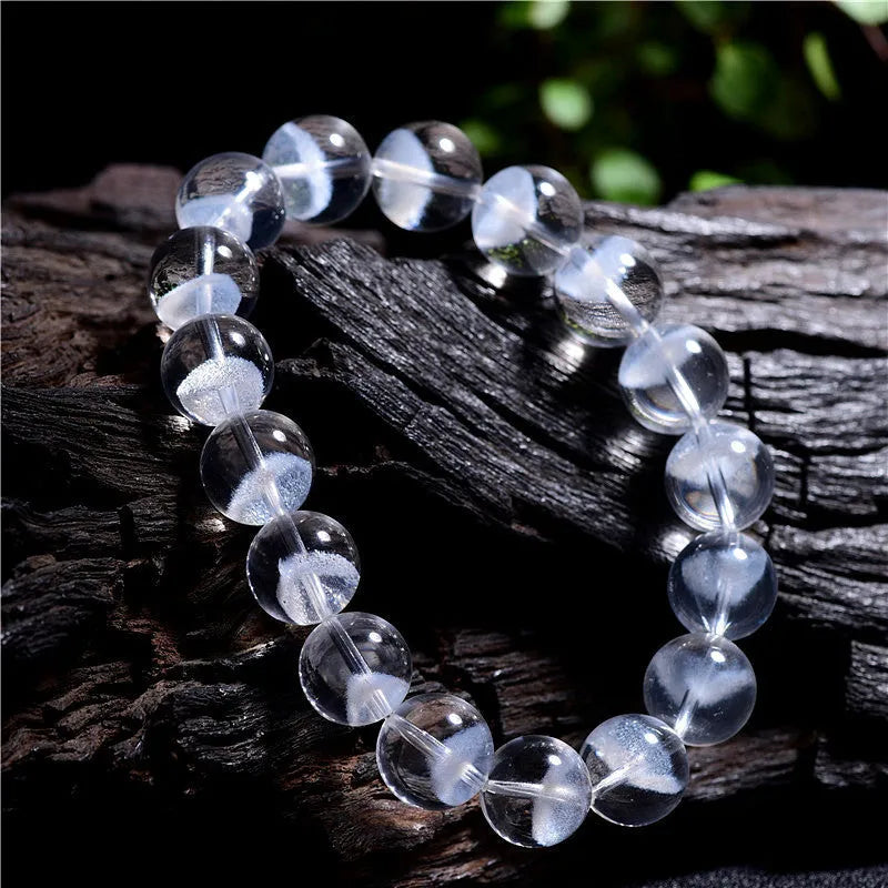 Women's white crystal ghost pyramid bracelet with Ruyi design elements on a wrist.