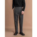 Men's straight-leg casual trousers in black, shown in a light business style setting.