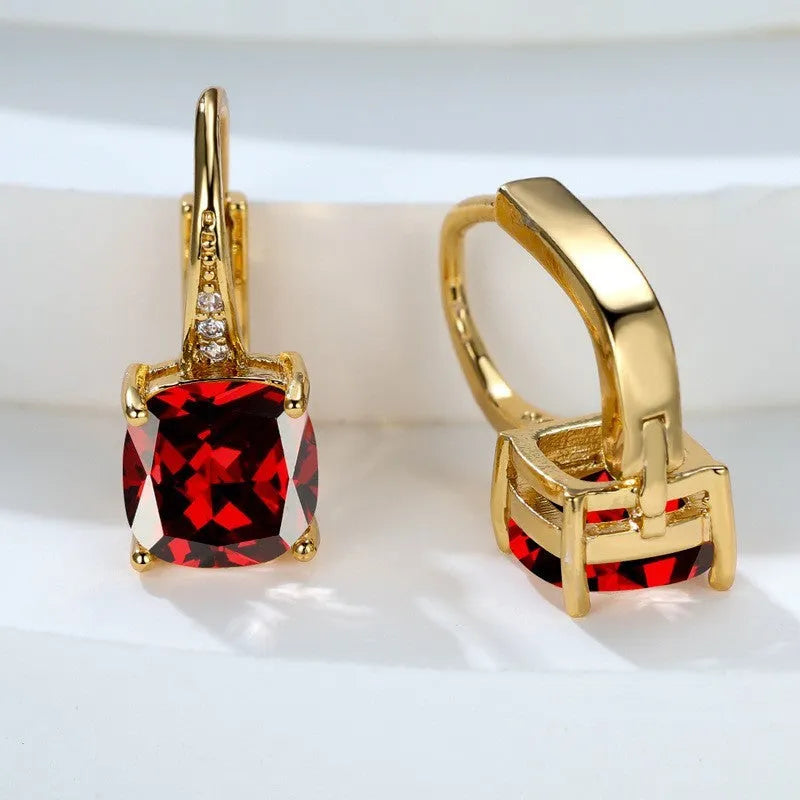 Geometric copper ear hook earrings with a square zircon stone in a rose gold electroplated finish.