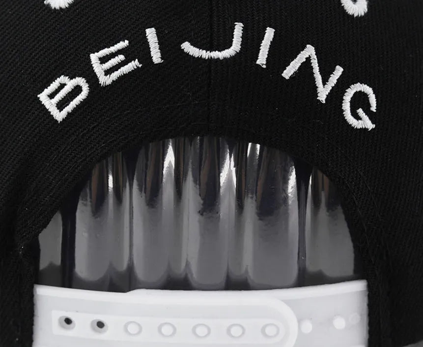 Cotton embroidered baseball cap with adjustable strap in black or white colours