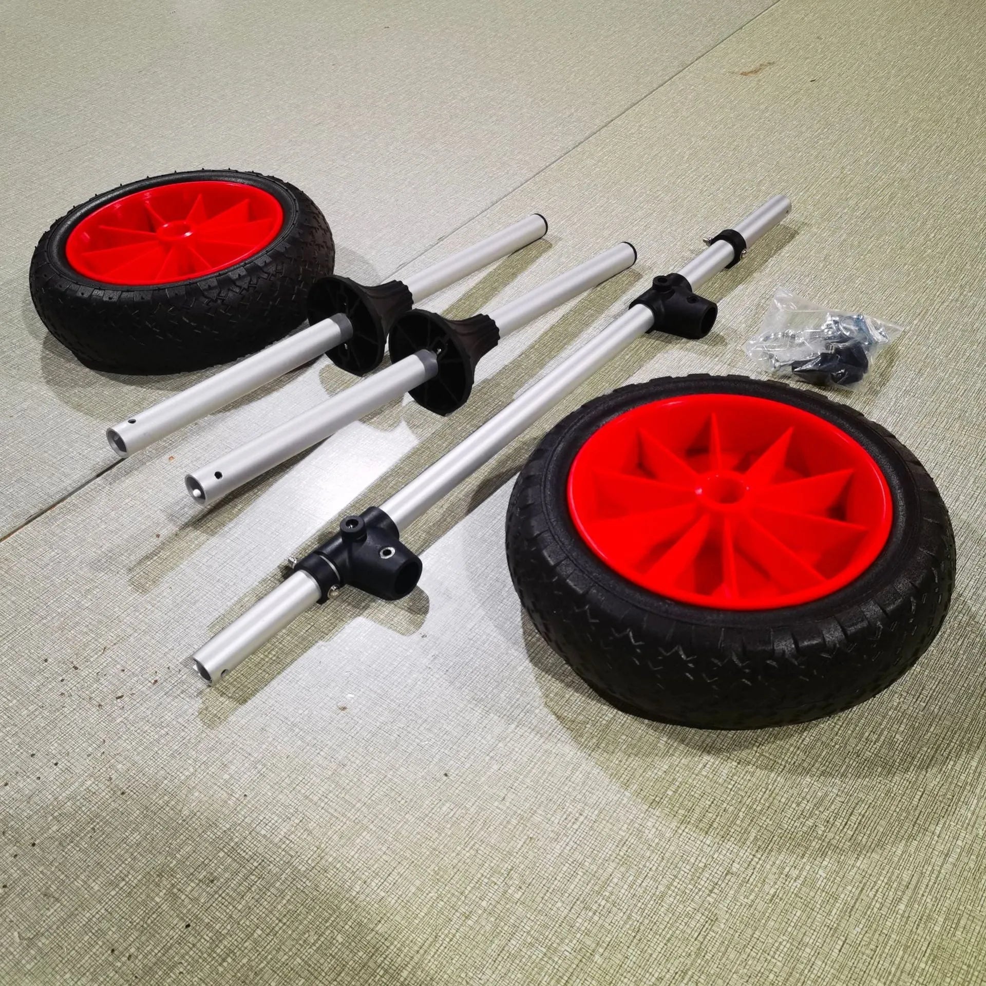 Foldable aluminium kayak cart with wheels and platform for transporting open kayaks.