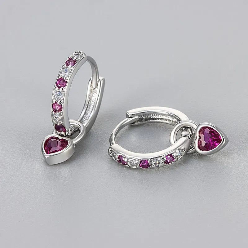 Women's gold-coloured heart drop earrings with a blue zircon stone centre and clip-on fastening.