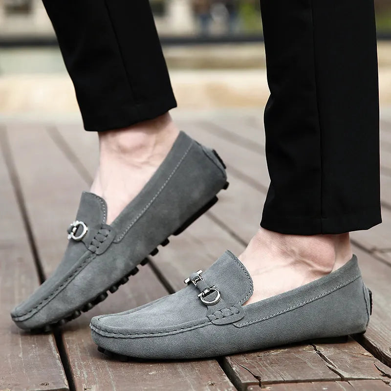 Men's black slip-on cowhide leather shoes with square toe and visible stitching on a rubber sole.